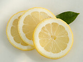 Three lemon slices on a light background