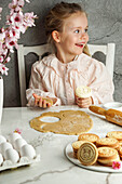 Girl prepares Easter biscuits