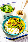 Yellow lentil curry with baby spinach and sesame tofu
