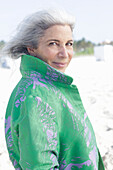 Gray-haired woman in a green coat