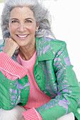 Gray-haired woman in a green coat