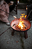 Barbecuing bread over a fire pit
