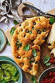 Focaccia with green olives, basil, and tomato sauce