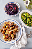 Red cabbage with apples, broccoli with almonds and mustard-glazed early potatoes