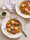 Beef broth soup with small dumplings