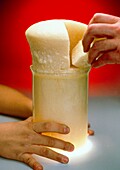 Beaker filled with polyurethane foam