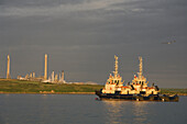 Tugs and oil refinery