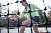 Woman playing tennis on tennis court