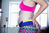 Pregnant woman in sports bra