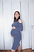 Smiling pregnant woman in dress