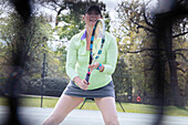 Pregnant woman playing tennis on tennis court