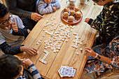 Family playing scrabble at dining table