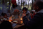Family eating at candlelit table