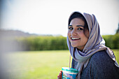 Woman in hijab drinking juice