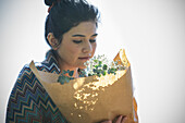 Young woman holding flower bouquet