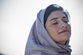Muslim woman in hijab with her eyes closed