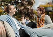 Happy couple talking on sunny patio