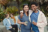 Happy pregnant couple on patio