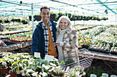 Happy couple shopping for plants in garden shop