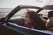 Happy woman in convertible