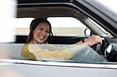 Happy woman driving car