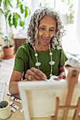 Woman painting at easel