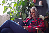 Woman using digital tablet at home