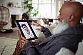 Man video chatting with doctor on digital tablet screen
