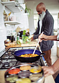 Couple cooking at kitchen stove