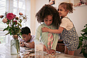 Brother and sisters playing at table