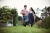 Happy couple walking on allotment