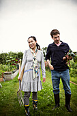 Couple with pitchfork and beets on allotment