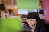 Businesswoman in headset working in office