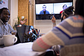 Business people video conferencing with colleagues in office