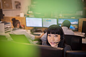 Smiling businesswoman in headset at office