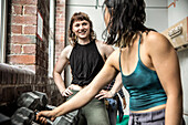 Smiling women friends working out in gym
