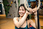 Portrait smiling woman at climbing center