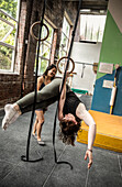 Woman training at gymnastics rings in gym