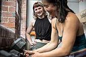 Smiling women friends working out at gym