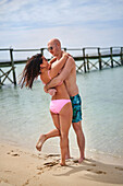 Couple hugging on sunny beach