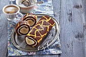 Two-colored sponge cake roulade with banana and cottage cheese filling