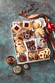 Assorted Christmas biscuits in compartments of a biscuit box