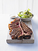 Chargrilled steak with english lettuce and herb salad and anchovy butter