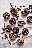 Donuts with blueberries berry topping and white chocolate