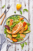 Salad with bulgur arugula avocado broad beans grilled halloumi peaches and chicken breast