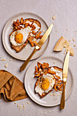 Garlic toasted bread with cheese, fried egg, chanterelles, and Parmesan cheese