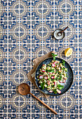 Cucumber salad with feta, mint, and radish on a tile background