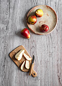Cape Fire Pears, whole and sliced on a wooden background