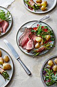 Lacquered roast beef with potatoes, bacon beans and wild herb salad