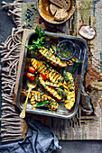 Grilled pineapple with pimento and chimichurri in a baking tray